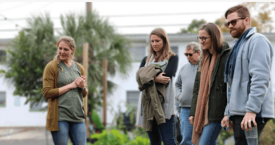 A small group in conversation while walking outdoors